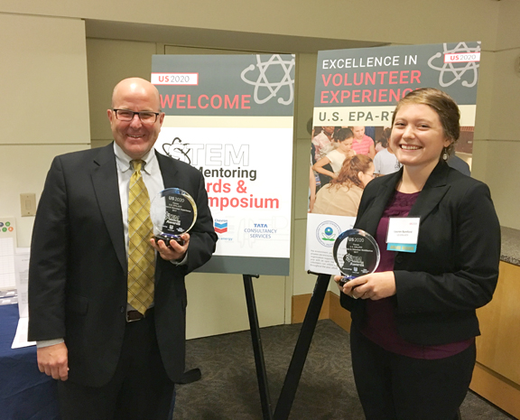 Tim Watkins and Lauren Bamford holding awards