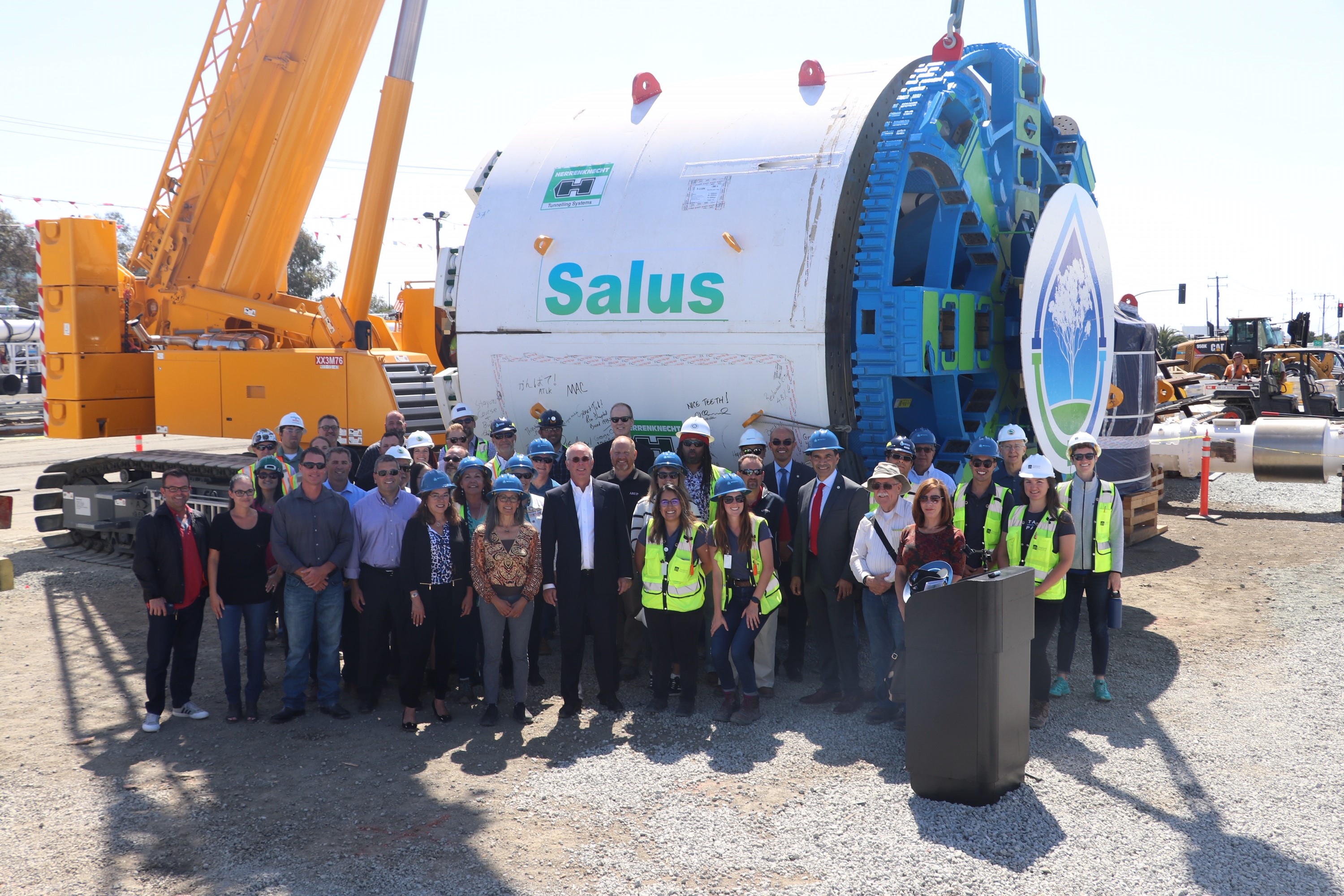 Representatives from EPA and Silicon Valley Clean Water and other dignitaries at the event and loan closing announcement, in front of a giangantic drilling machine..