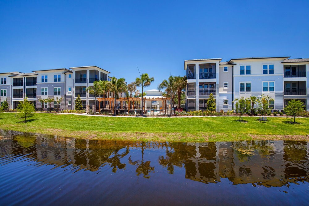 Linden Audubon Apartments next to water, a green area, and a walkway