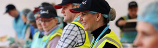 This is a picture of several people serving food