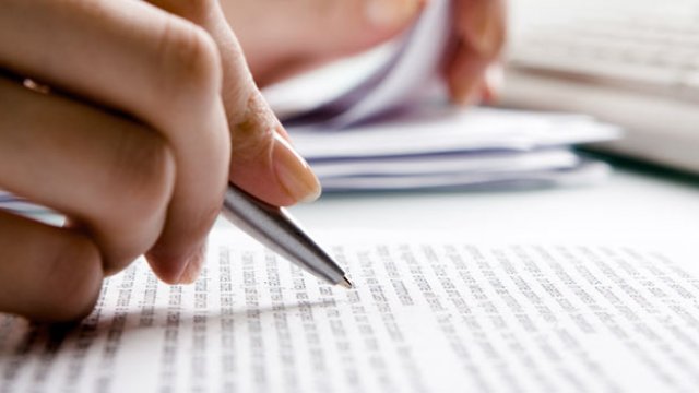 Person writing on a peice of paper