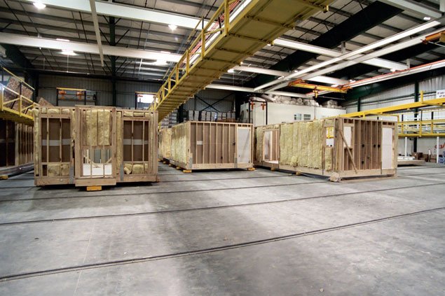 Factory floor with several modular homes under construction