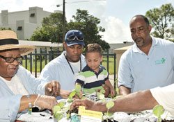 adults and a child at a table outside about to eat food