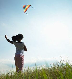 Girl flying a kite.