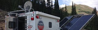 Cropped image of truck and solar panels at waste site