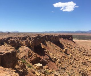 Photograph of mine area with blue sky and cloud