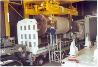 A dual-purpose spent nuclear fuel cask being loaded onto a heavy haul road vehicle. 