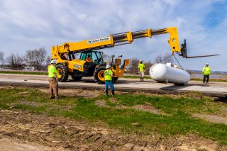 image of crane lifting tank after Iowa floods