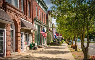 A downtown main street with a wide sidewalk