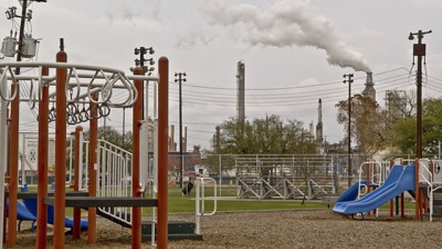 Playground with an industrial site with visible air emissions in the background