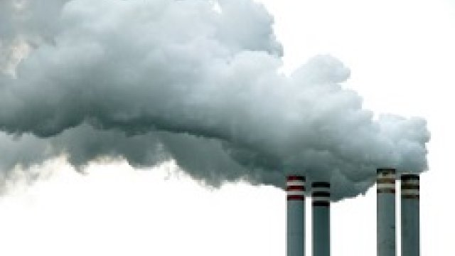 White steam emitting from four smoke stacks