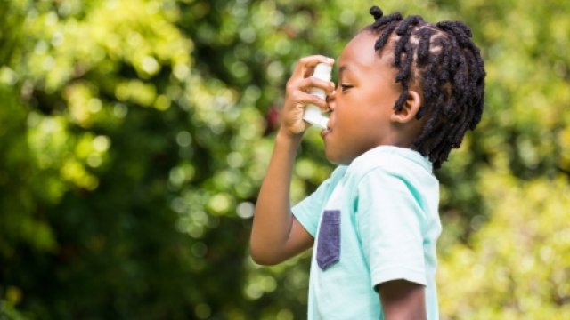 Child using a rescue inhaler.