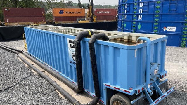 A weir allows sediment and dirt to settle before being pumped into the blue lake tanks for staging