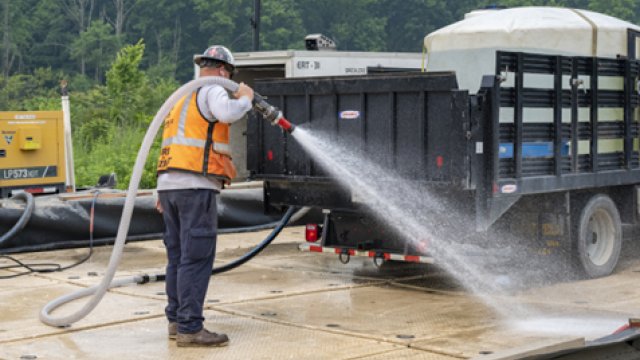 Decontamination station spraying down trucks