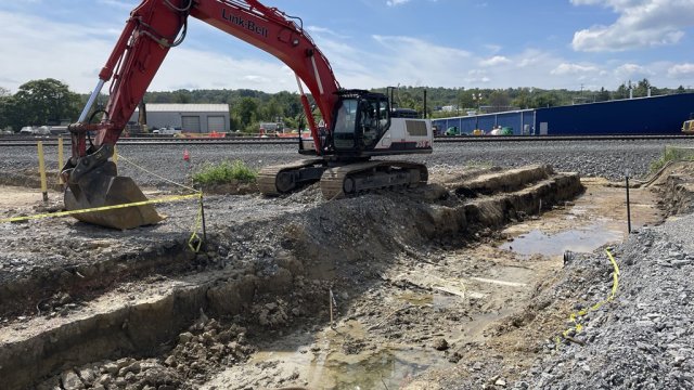 Large machinery excavating pit in Car Scrapping Area 3