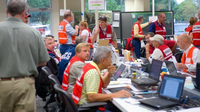 Emergency planners in a room with tables and laptops