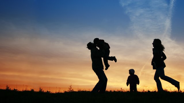 Family silhouette and a sunset sky