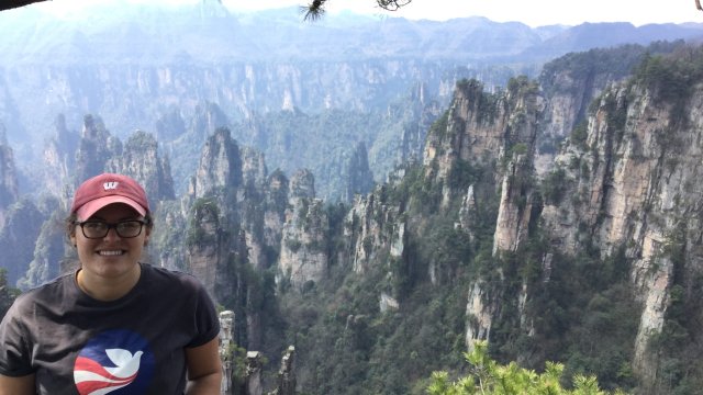 Rebecca Taylor posing outside in front of a Chinese valley