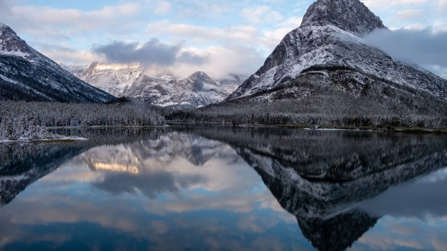 Mt Grinnell reflected in Swiftcurrent Lake in the early dawn light at Glacier National Park in Montana. Adobe Stock image.