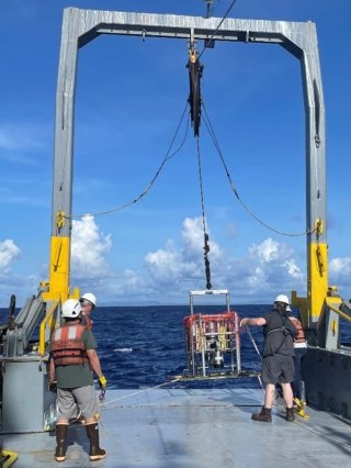 Lowering the underwater camera to take pictures of sediment