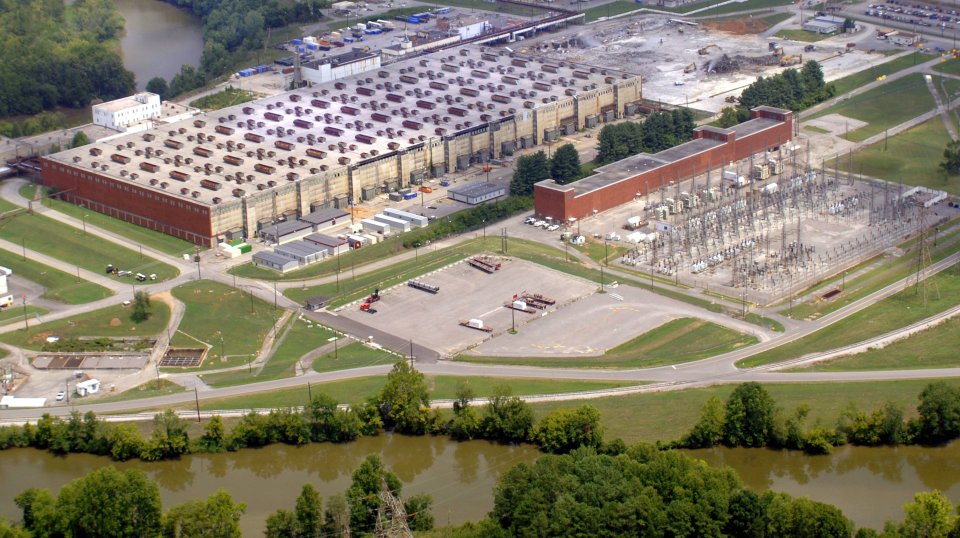 An aerial image showing a river and a large industrial facility.