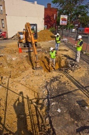 Workers and equipment digging at a UST site