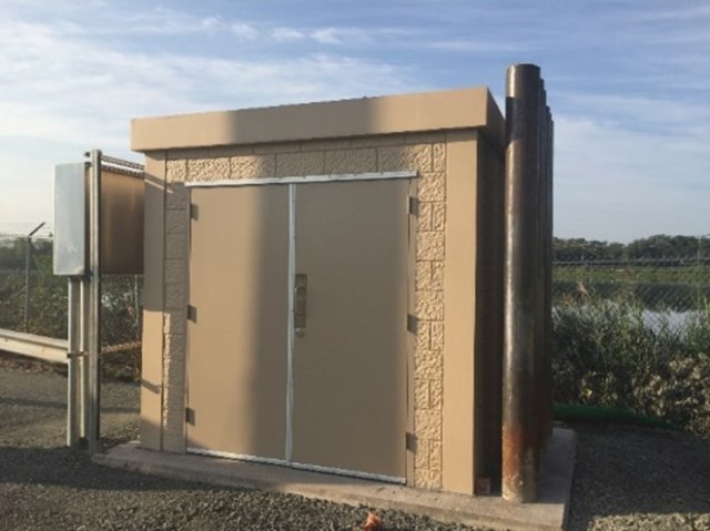 Photograph showing a flood resistant building including steel poles to protect against debris