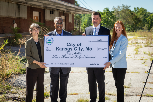 photo of dignitaries holding big check