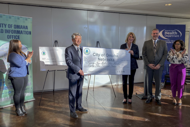 Group photo of ceremonial check resentation to Omaha