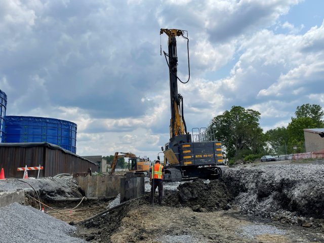 Large scale machinery excavating underneath Pleasant Drive