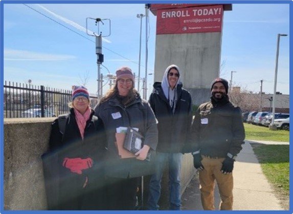 EPA Region 5’s Kathy Kowal, Sheila Batka, Rich Baldauf and Parik Deshmukh pose outside next to one of the school’s fixed monitoring sites on a cold Chicago morning.