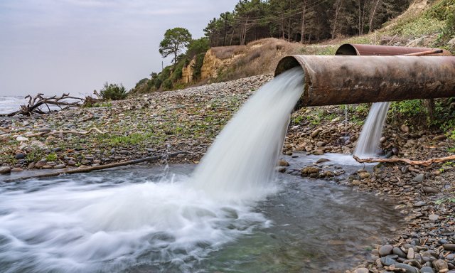 Pipe delivers chemical waste into a water source