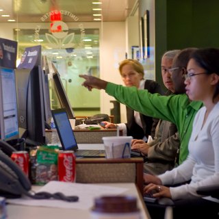 People at a table working on computers