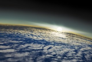 A view of the Earth from space with clouds visible in the atmosphere.