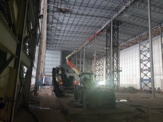 Interior of Segment 3 building with workers and demolition equipment.