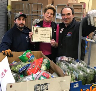 Image of a group of people in front of boxes of food/produce at Golub Corporation.