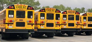 school bus parking lot on cloudy day