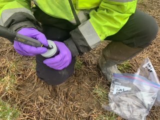 Person collecting soil and labeling container