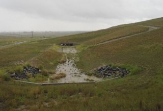 Photograph showing surface water draining from the site