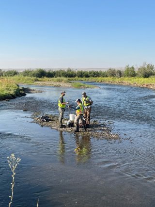 People taking samples in a river