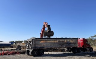 Hazardous soil is loaded for off-site disposal