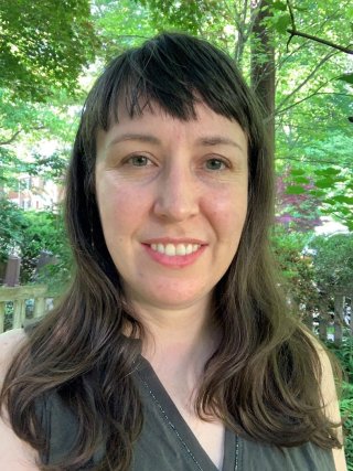 EPA Epidemiologist Rebecca Massa Nachman smiling for a selfie outside in a forest