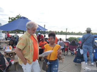 A volunteer in Buffalo talking to a community member about the air monitoring project. 