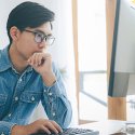 Man sitting starting at a computer