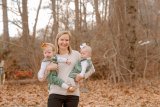 Lauren Duffy outside in the woods holding her twins